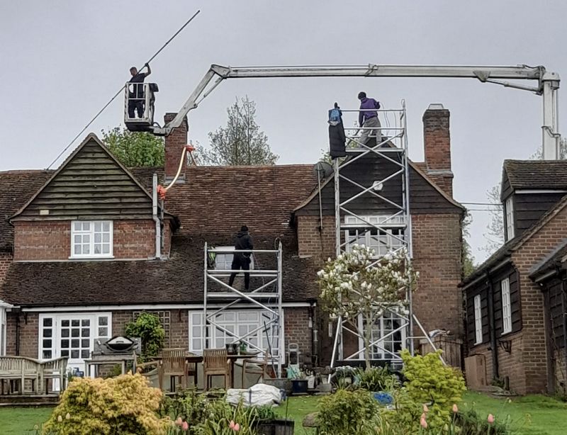 The Roof Moss Cleaners using cherry picker and scaffolding to clean roof safely and professionally in Atherstone, Warwickshire